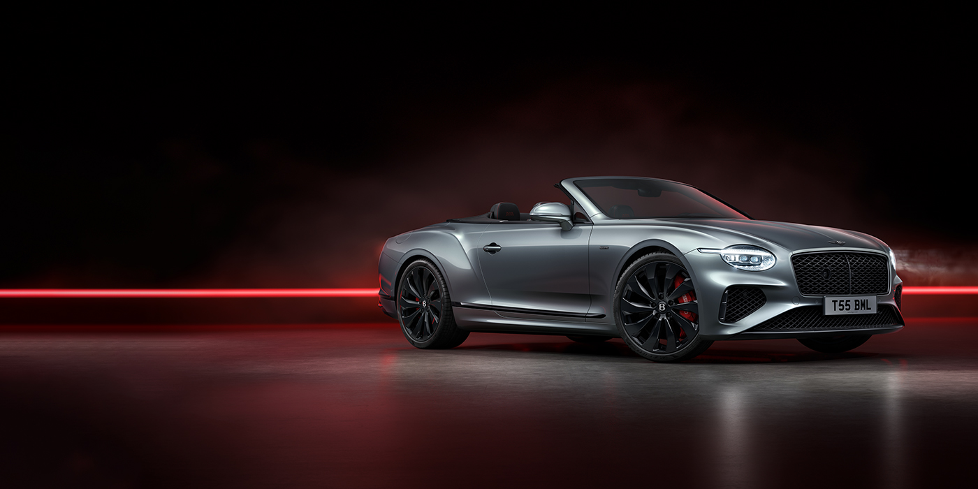 Bentley Hampshire Bentley Continental GTC Black Edition convertible front three quarters in Hallmark silver against a dark grey and red background