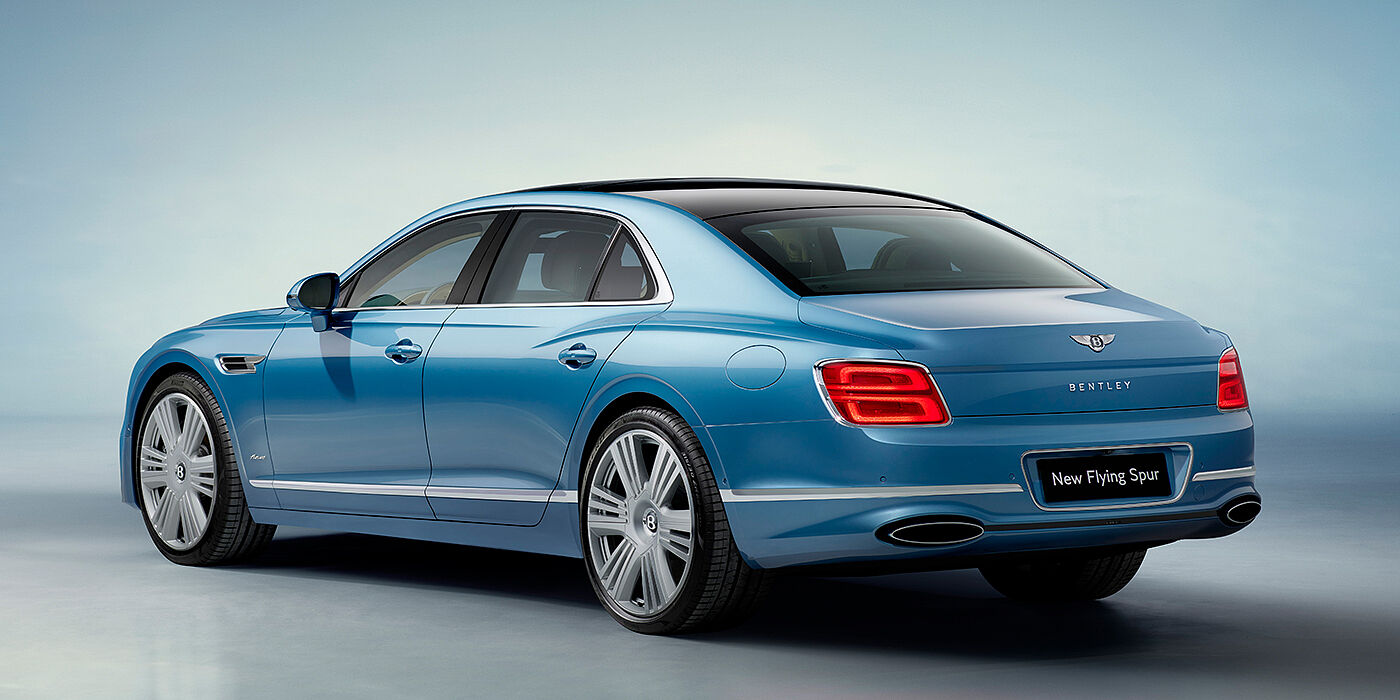 Bentley Hampshire New Bentley Flying Spur Azure sedan rear view in Light windsor blue by Mulliner paint with 22 inch Azure wheels and chrome exterior details