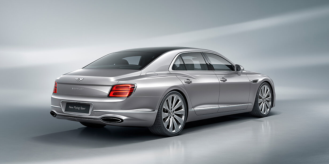 Bentley Hampshire New Bentley Flying Spur sedan rear view in Silverlake paint with ten spoke wheels and chrome matrix grille