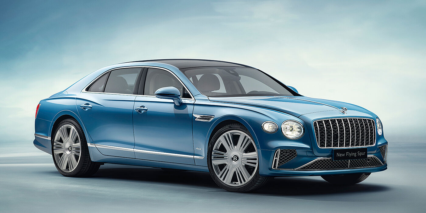 Bentley Hampshire New Bentley Flying Spur Azure sedan front view in Light windsor blue by Mulliner paint with 22 inch Azure wheels and chrome exterior details