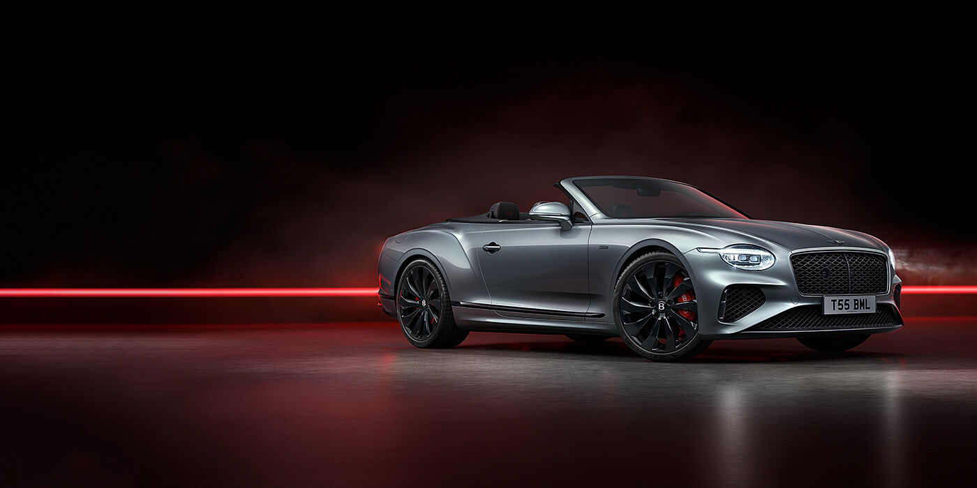 Bentley Hampshire Bentley Continental GTC Black Edition convertible front three quarters in Hallmark silver against a dark grey and red background