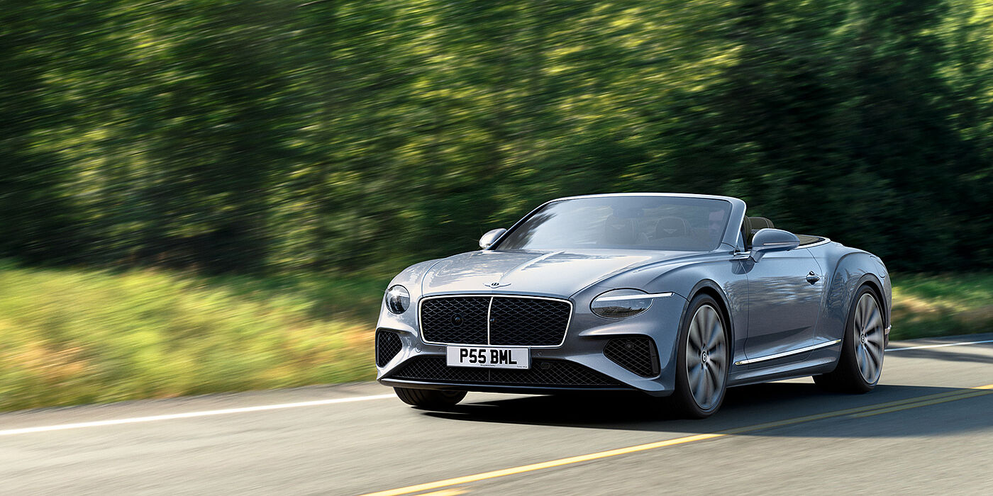 Bentley Hampshire New Bentley Continental GTC convertible front view in Silverlake paint with 22 inch ten spoke wheels, driving dynamically on a country road