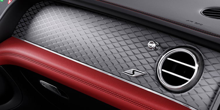 Bentley Hampshire Bentley Bentayga S SUV front interior dash with Dark Tint Diamond Brushed Aluminium veneer and S badge surrounded by Hotspur red and Beluga black hide