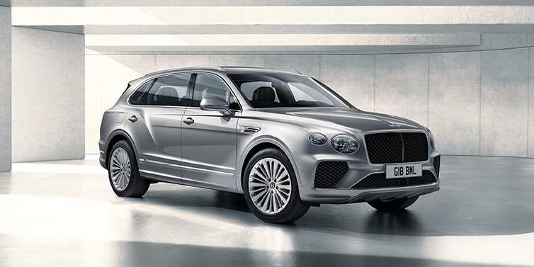 Bentley Hampshire Bentley Bentayga Extended Wheelbase SUV front three quarter in Moonbeam paint with a grey background