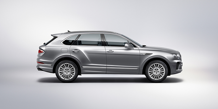 Bentley Hampshire Bentley Bentayga SUV side profile in Moonbeam silver paint against white background featuring 21 inch 5 spoke wheels
