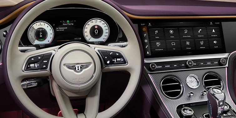 Bentley Hampshire Bentley Continental GTC Mulliner convertible steering wheel and drivers screens surrounded by Damson purple and Linen hides